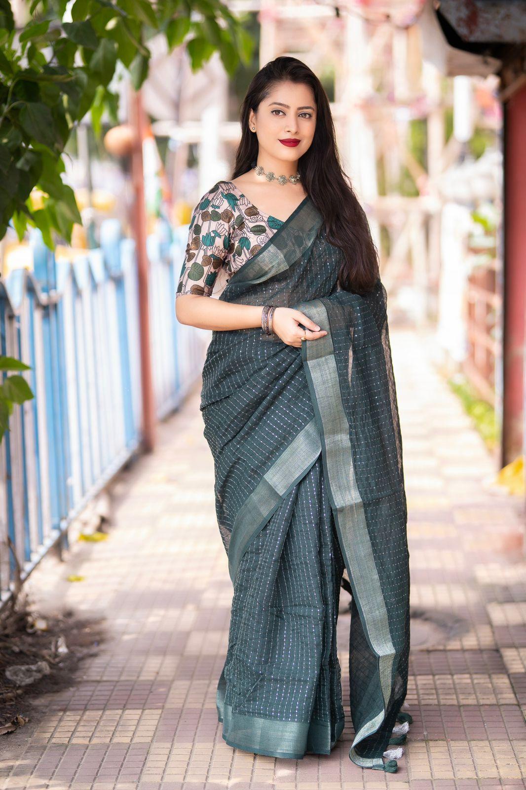 Green linen saree with self-weaving checks and golden pattu border
