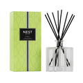 Nest New York Bamboo Reed Diffuser in a clear glass bottle with lime green label and black accents.