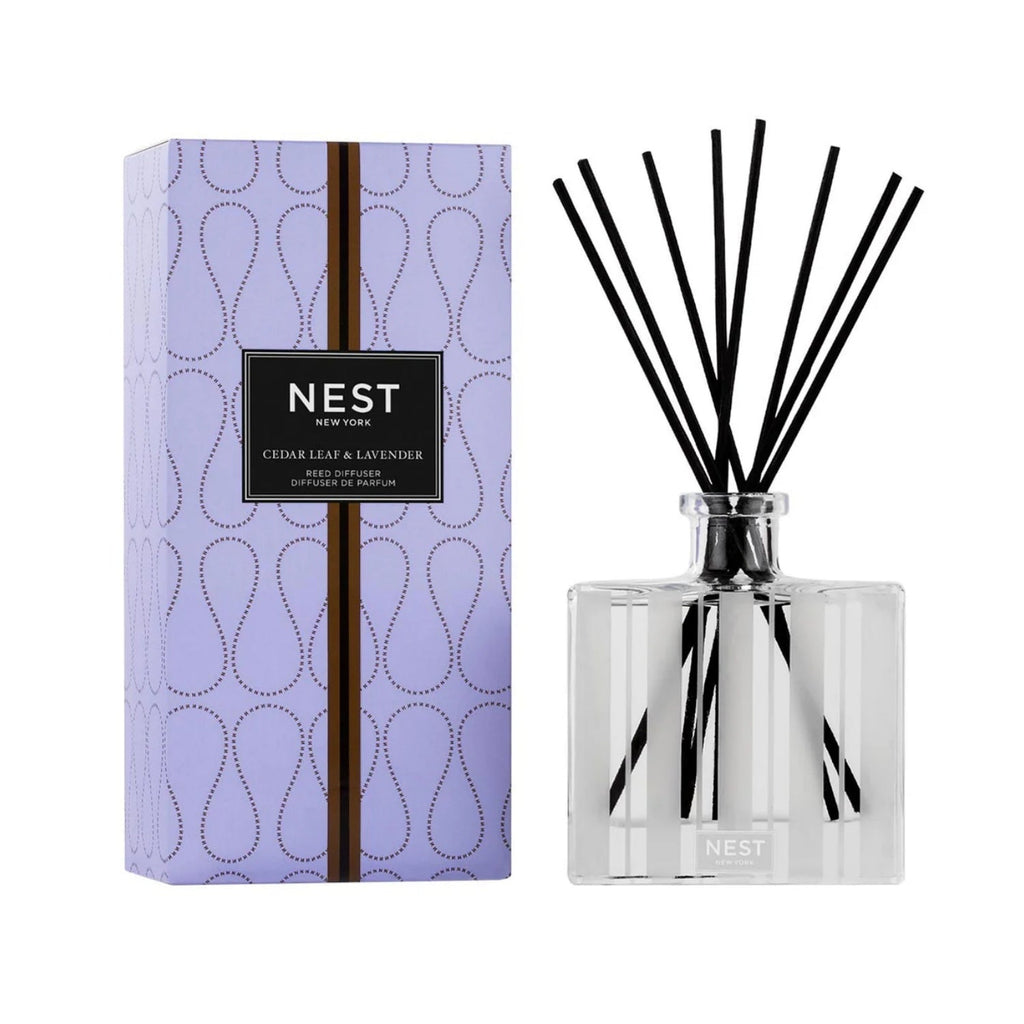 Cedar Leaf & Lavender reed diffuser with natural wooden reeds in a minimalist glass bottle