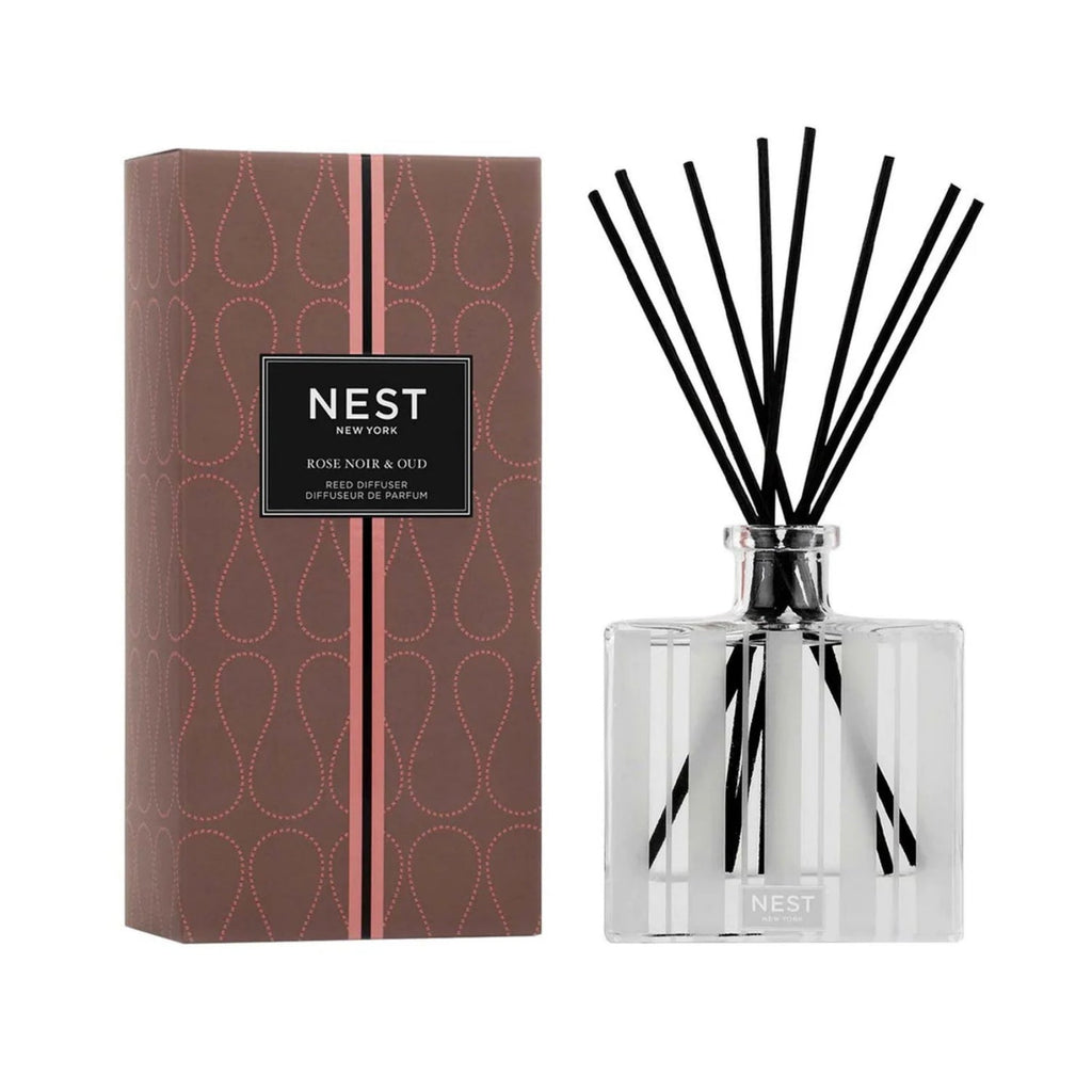 Elegant glass reed diffuser bottle featuring Rose Noir & Oud fragrance on a marble surface