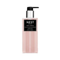 Minimalist clear bottle of Nest New York Himalayan Salt and Rosewater liquid soap with a soft pink tint on a white surface.