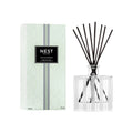 Indian Jasmine 5.9 oz reed diffuser in a modern striped glass bottle with a minimalist aesthetic.