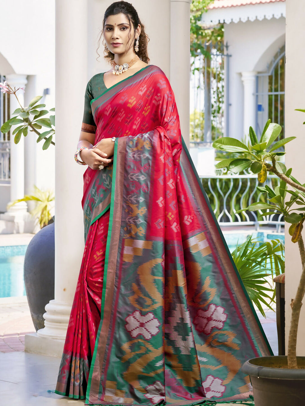 Classic red Pochampalli silk saree with a contrasting Rama blouse.
