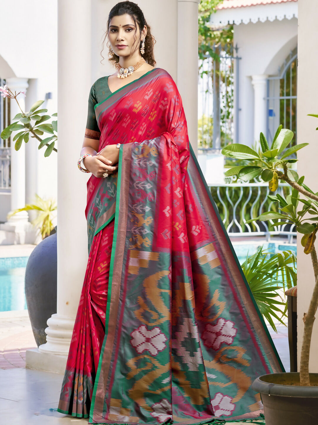 Classic red Pochampalli silk saree with a contrasting Rama blouse.