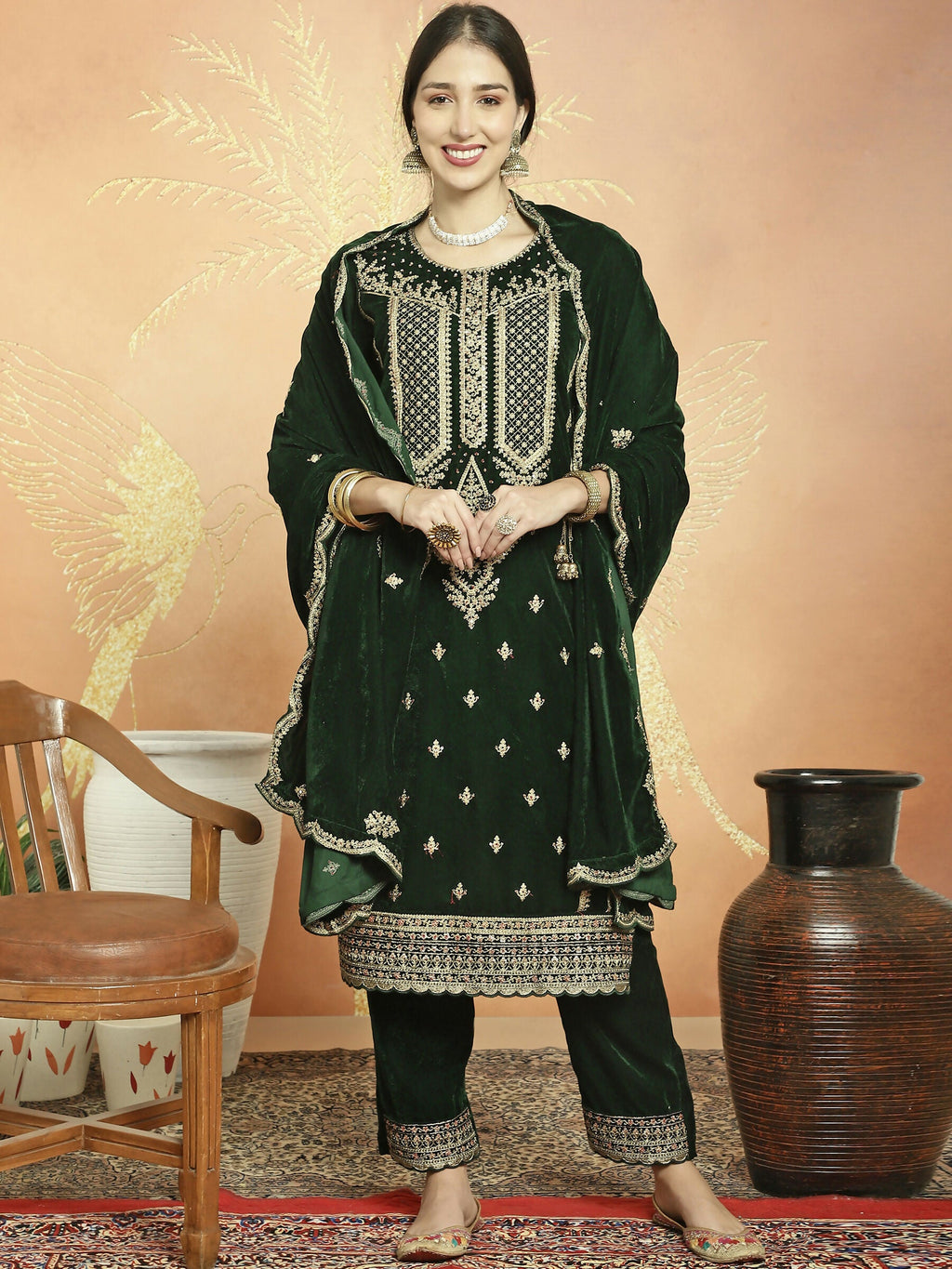 Green velvet straight kurta with cording, sequin, and Resham embroidery, including trousers.
