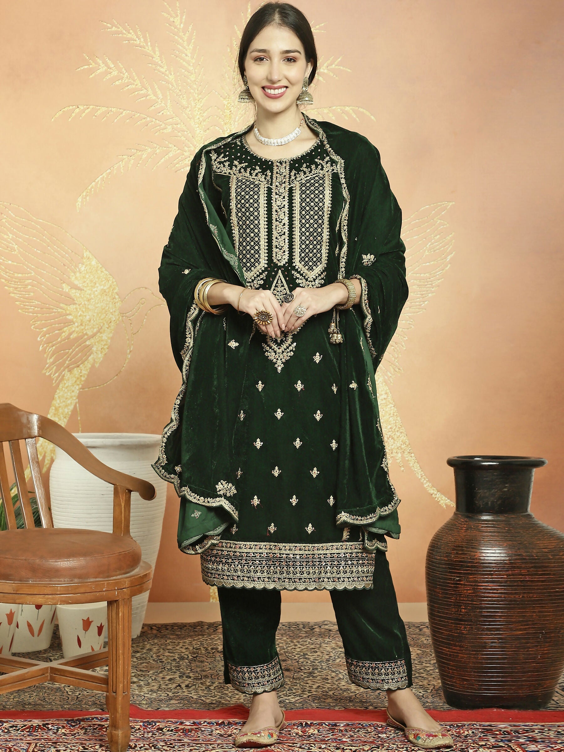 Green velvet straight kurta with cording, sequin, and Resham embroidery, including trousers.