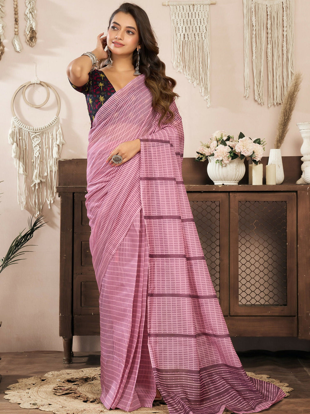 Coral Pink linen ready-to-wear saree with paisley and geometric patterns and a black unstitched blouse.