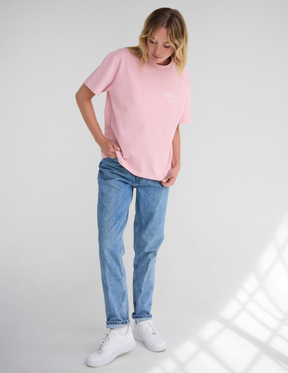 No Greater Love unisex graphic tee in Nectar pink cotton with white text