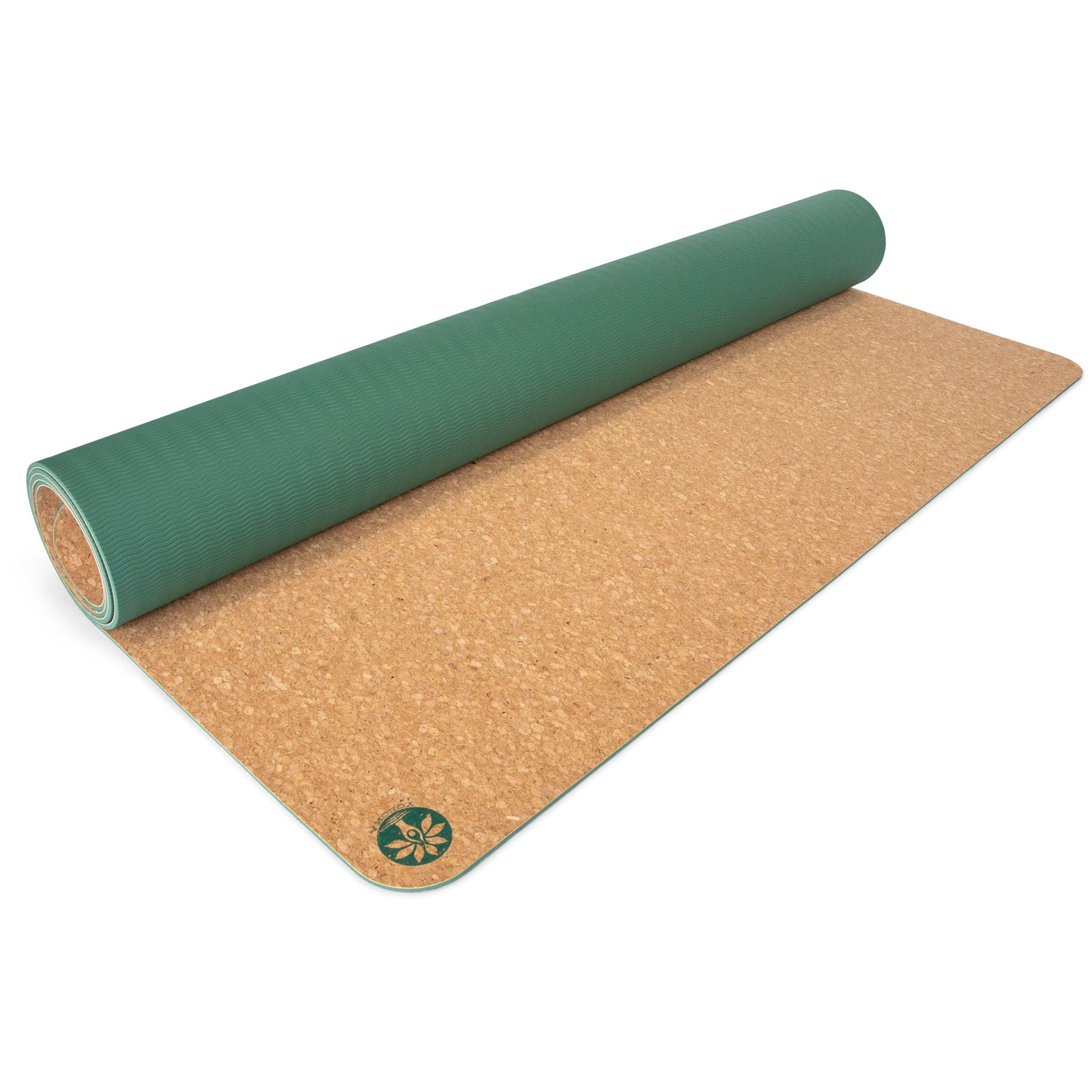 Nomad XL cork yoga mat in natural tan and forest green displayed in a minimalist studio setting