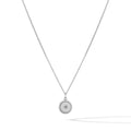 Close up of a North Star pendant necklace in sterling silver on a minimalist background