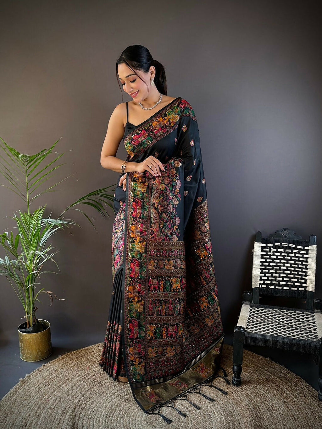 Elegant black soft silk saree featuring intricate Meena weaves with an unstitched blouse piece