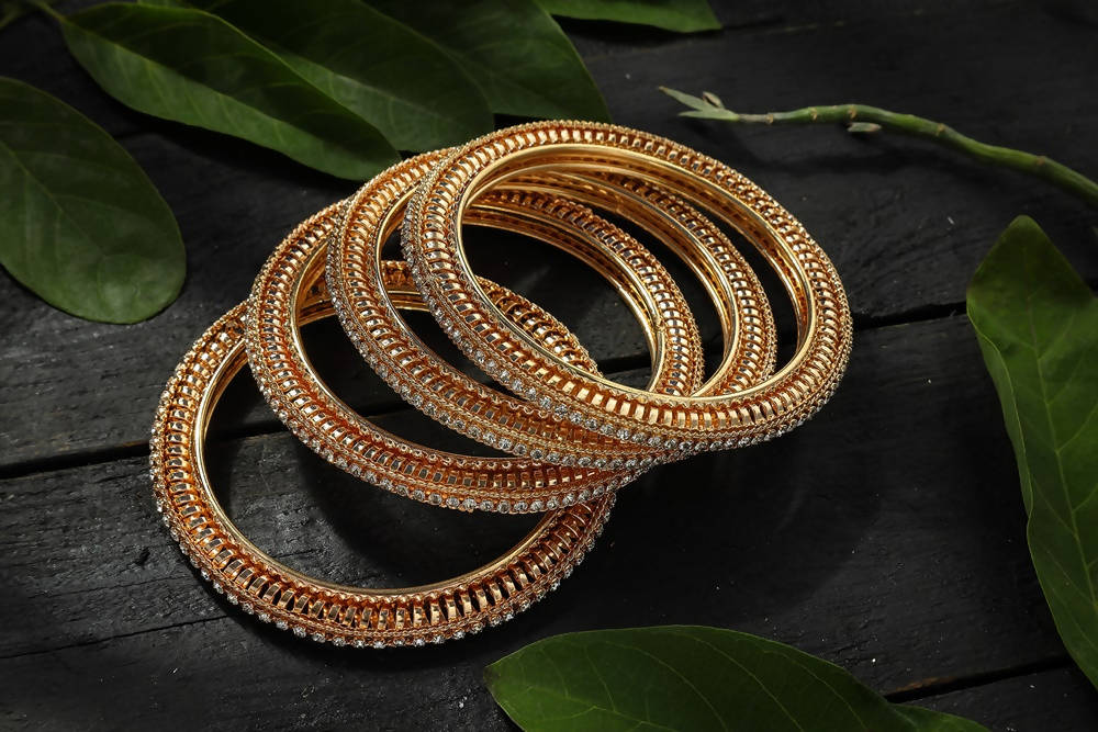 Luxury golden bangle set adorned with sparkling white stones