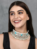 Close-up of a white bead silver-tone statement necklace with intricate patterns and stone details