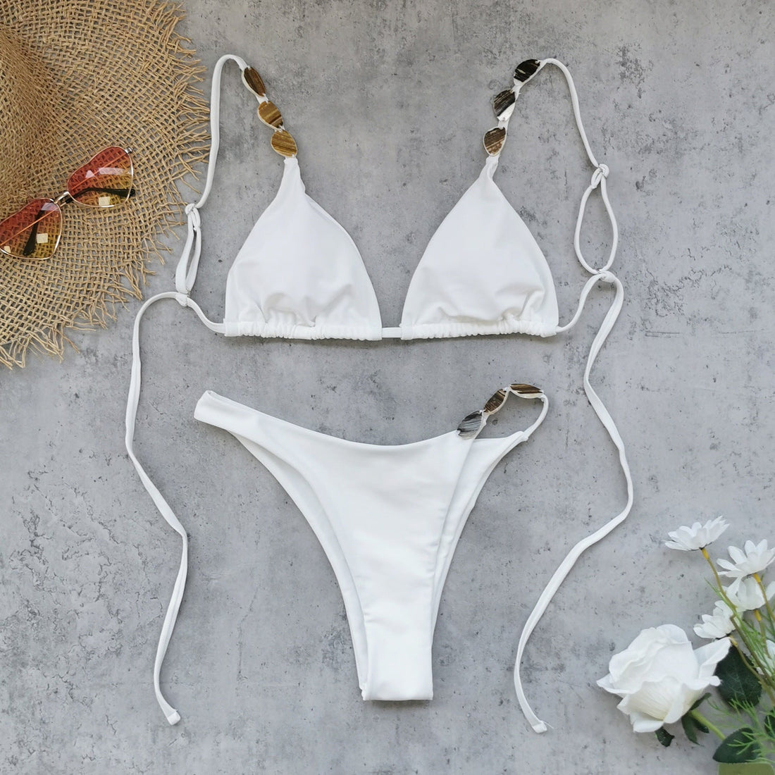Woman wearing a pure white three-point backless bikini with ruched asymmetric details