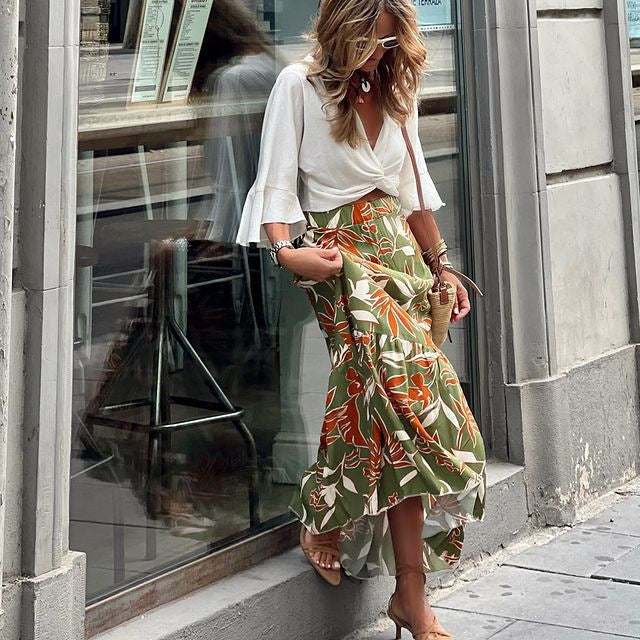 A woman wearing a green floral print long casual skirt, perfect for holiday vacation style.