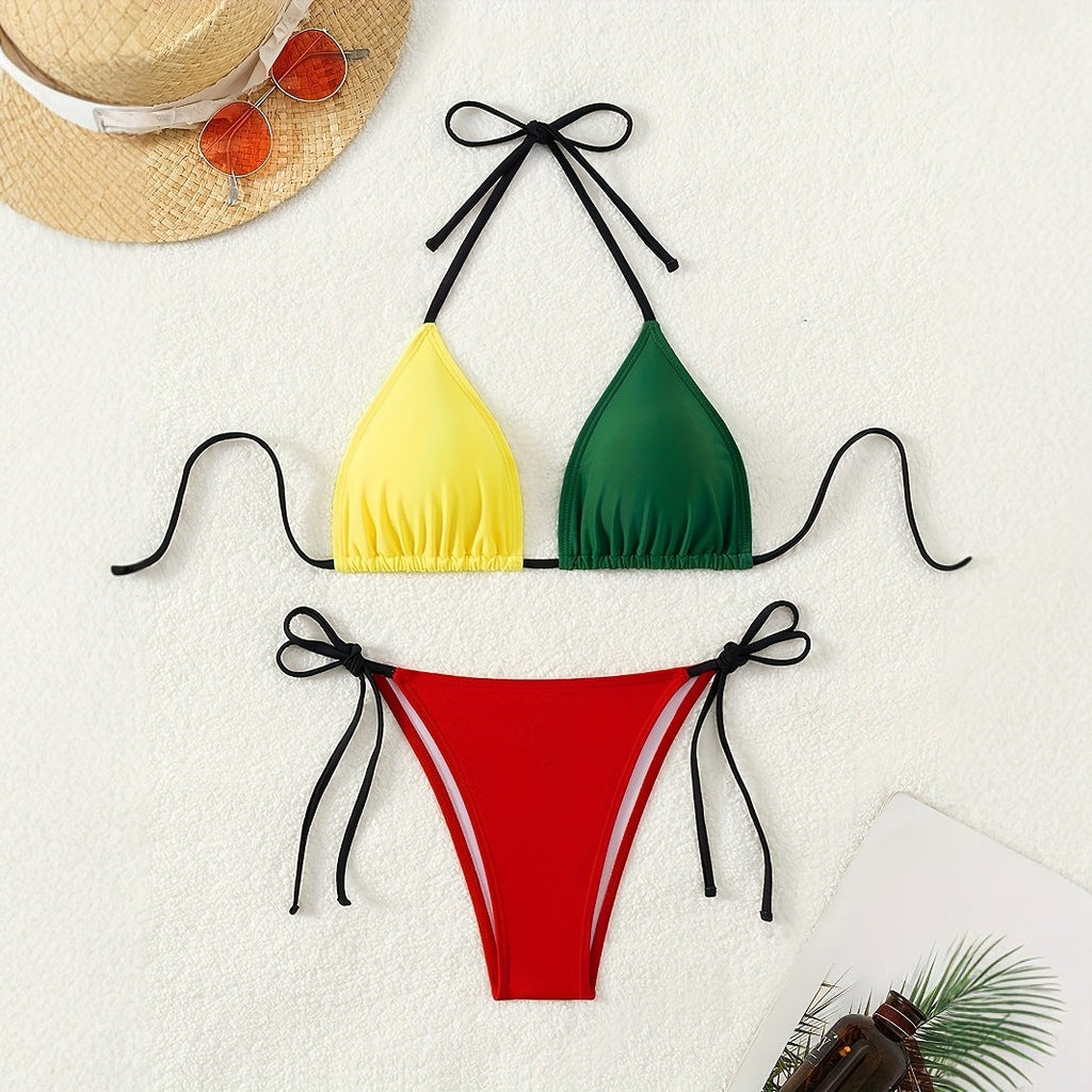 Model wearing a vibrant color-block bikini with halter straps in yellow, green, red, and black.
