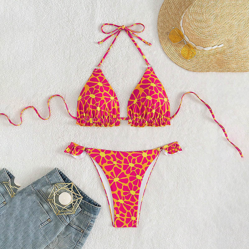 Vibrant floral print halter bikini with ruffle trim and ring detail, available in pink and yellow.