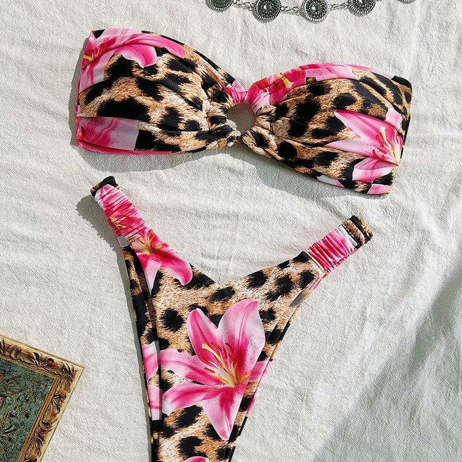 A woman wearing a printed cutout ruched bikini with ring detailing at the beach
