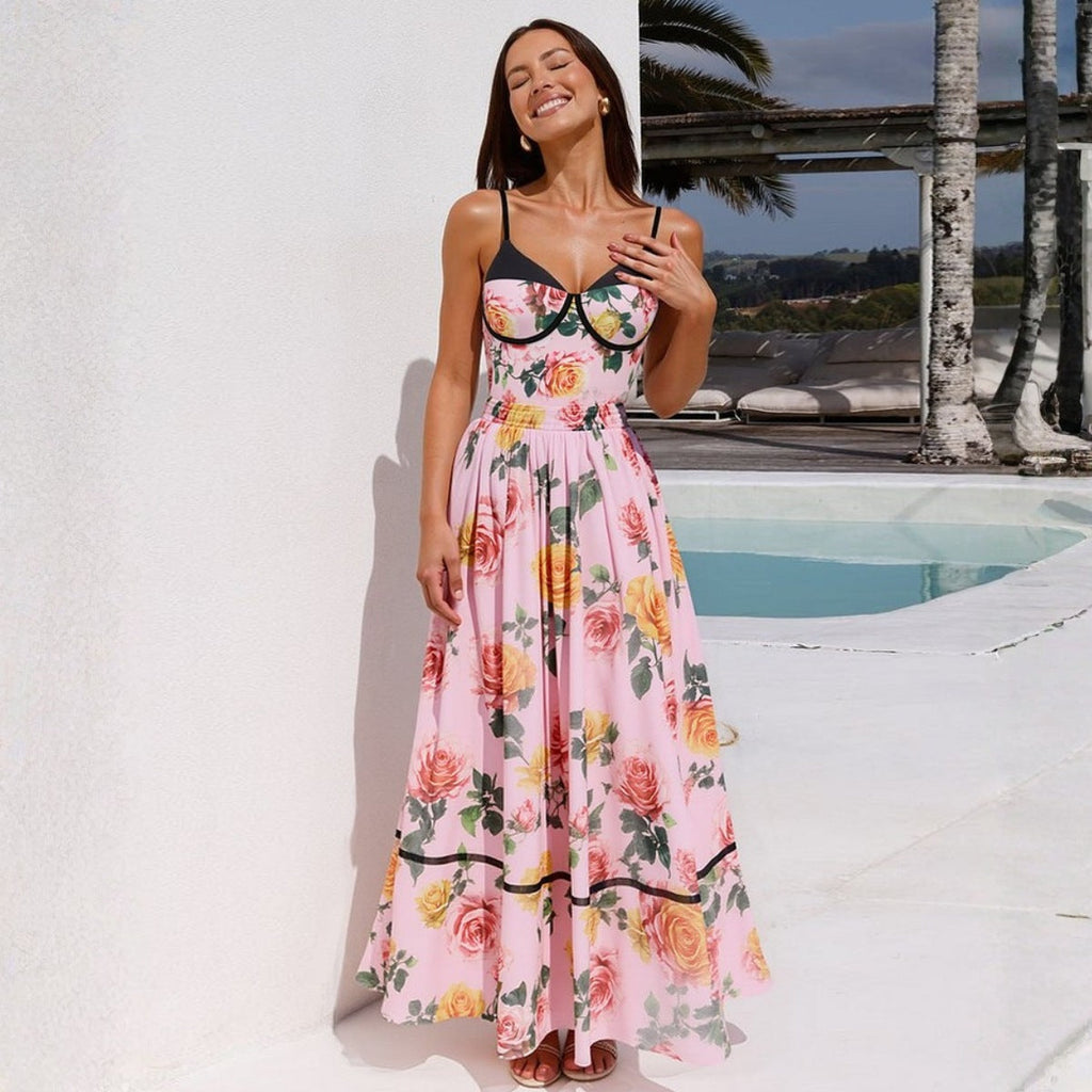 Woman wearing a pink floral asymmetric ruched swimsuit set for a summer vacation.