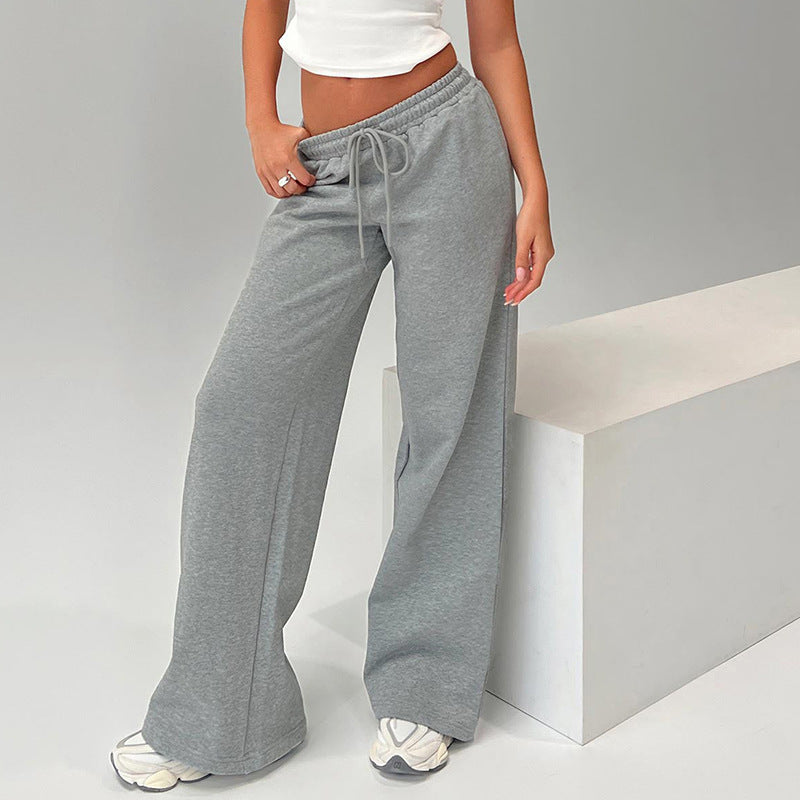 Model wearing Bella Mia casual loose drawstring wide-leg polyester pants in grey, showcasing the comfortable fit and relaxed style. A second image shows the same pants in black.