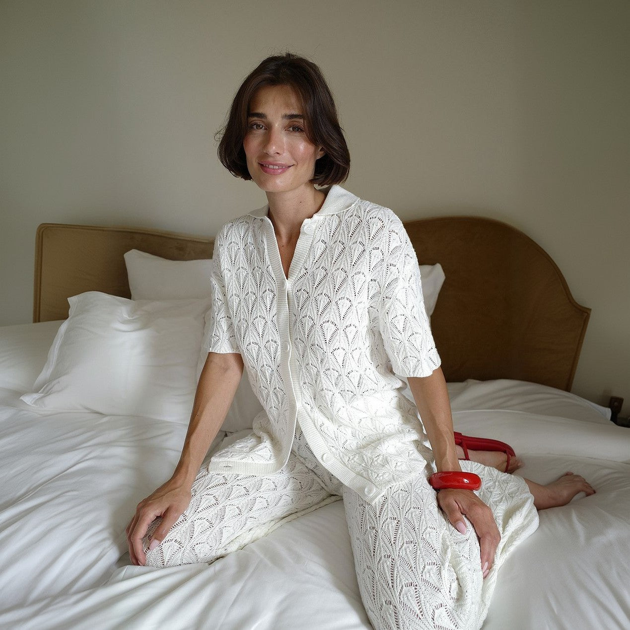 Model wearing a loose-fitting long sleeve two-piece beach set with button details in a solid color.