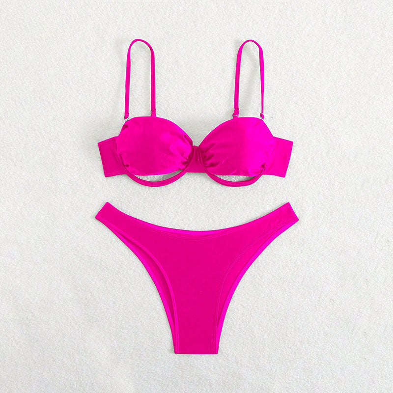 Vibrant hot pink bikini featuring cutouts and ruching details.