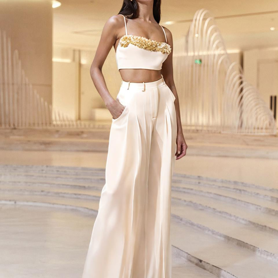 Model wearing a Bella Mia White Slim Fit Two-Piece Set with a rhinestone crop top and high-waist wide-leg pants.