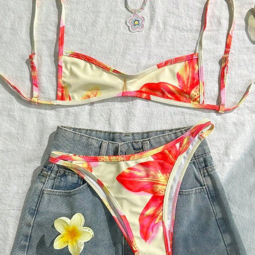 Woman wearing a floral print exposed back bikini with tie-strap detailing at the beach.