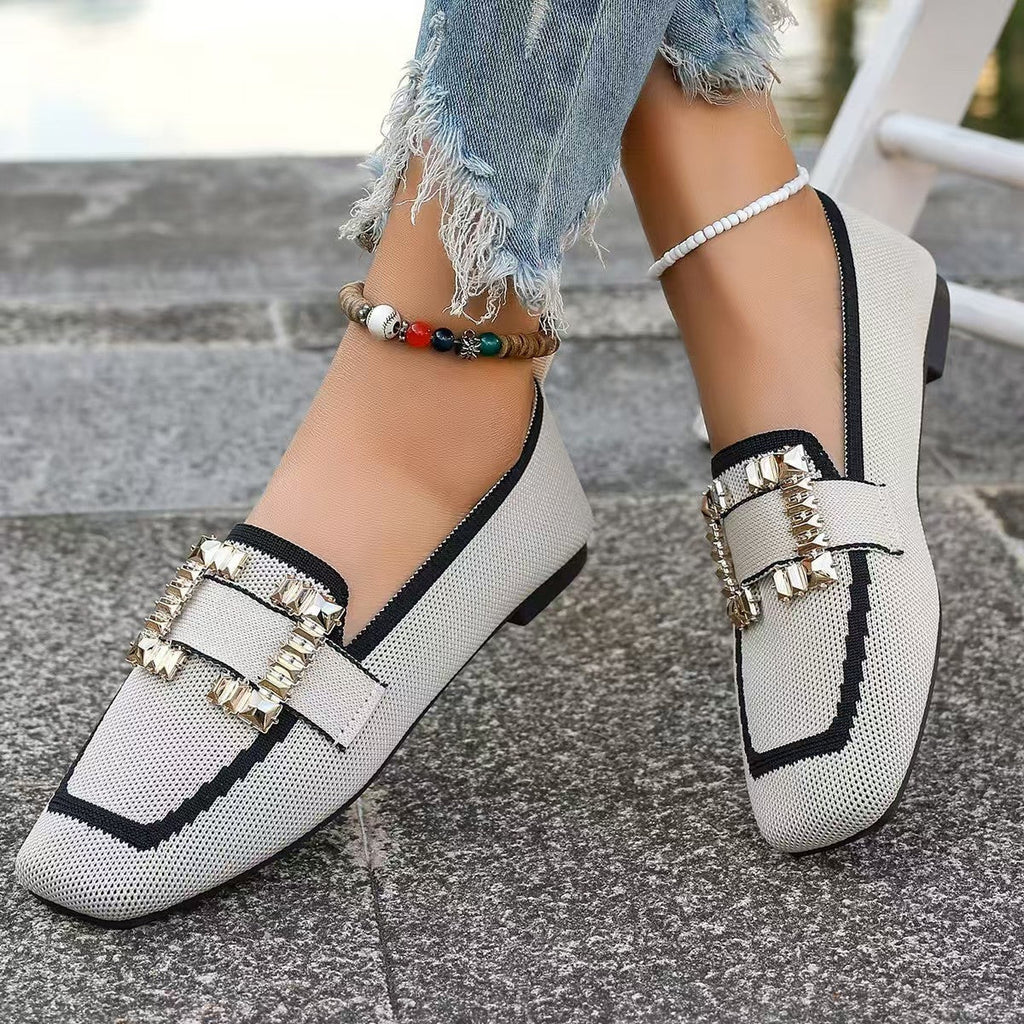 Close-up of stylish women's knit loafers with square toe and gold-tone embellished buckle