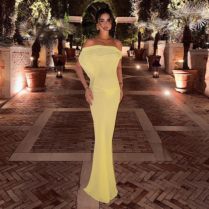 Stylish yellow sheer mesh backless sheath dress with ruched tie details.