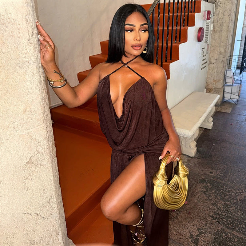 Model wearing a deep V-neck halter dress with an asymmetric split and ruched waist.