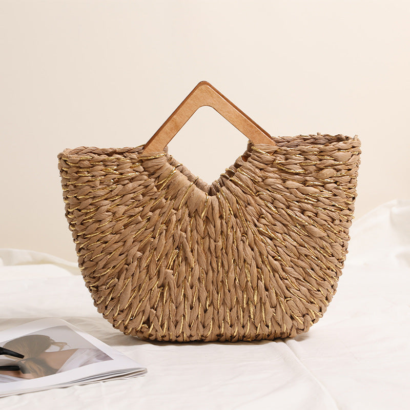 Diamond shaped woven straw handbag with wooden handles and gold silk detailing