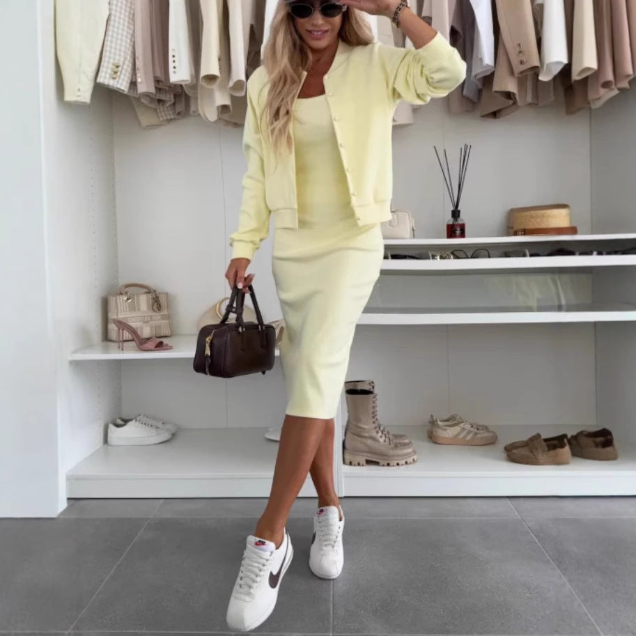 Woman wearing a solid color sling dress and matching long-sleeve button-down cardigan set