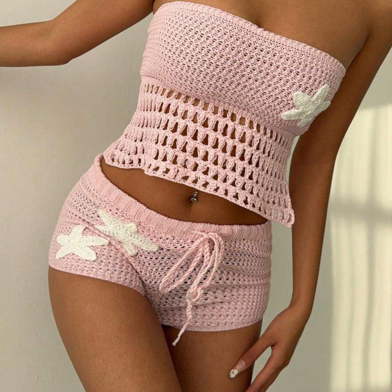 Woman wearing a backless knitted beach blouse and skirt bikini cover-up set