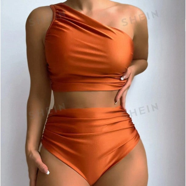 High waisted bikini with ruched sides and asymmetric single strap design in a summer boho style.