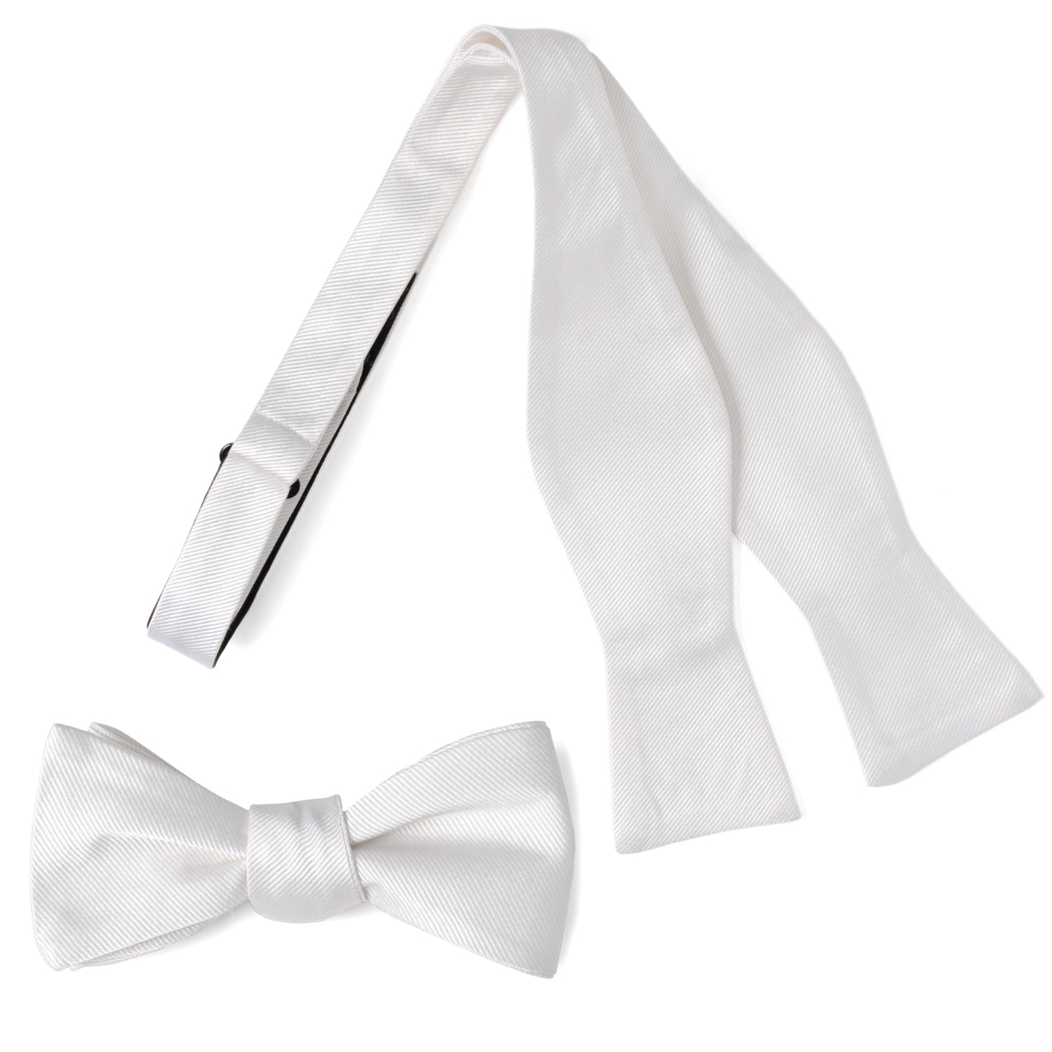 A classic white silk self-tie bow tie displayed next to its adjustable strap, and a second image showing the bow tie styled with a grey suit jacket.