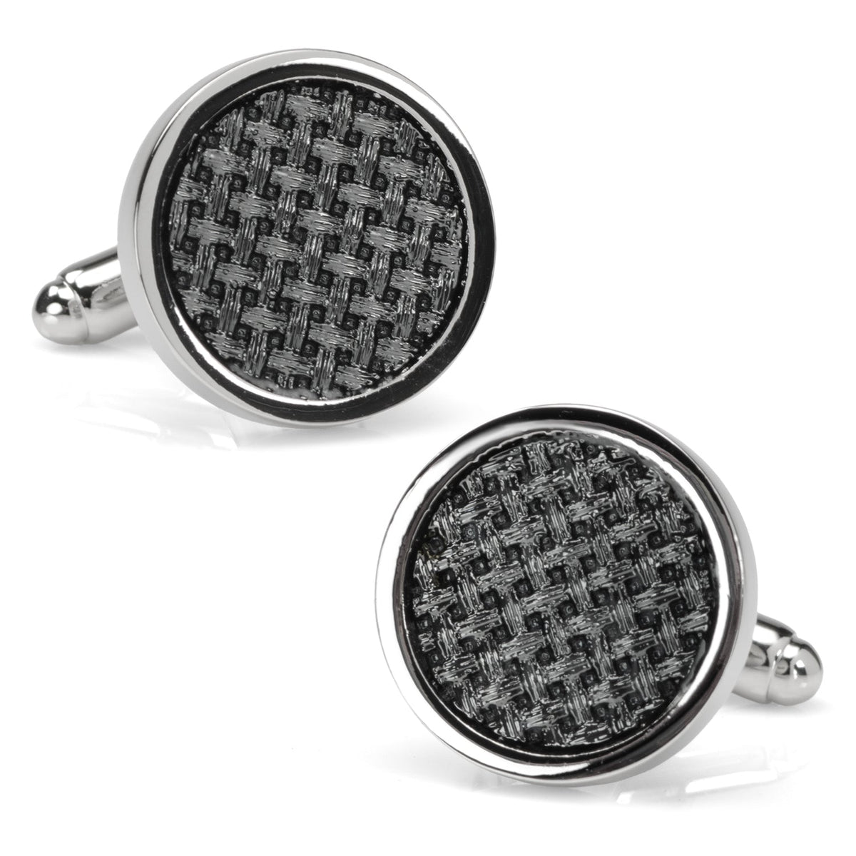 A pair of round black woven metal cufflinks with polished silver edges worn on a dress shirt cuff