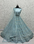Aqua heavy net wedding lehenga with dori, multi-thread, and rainbow sequins