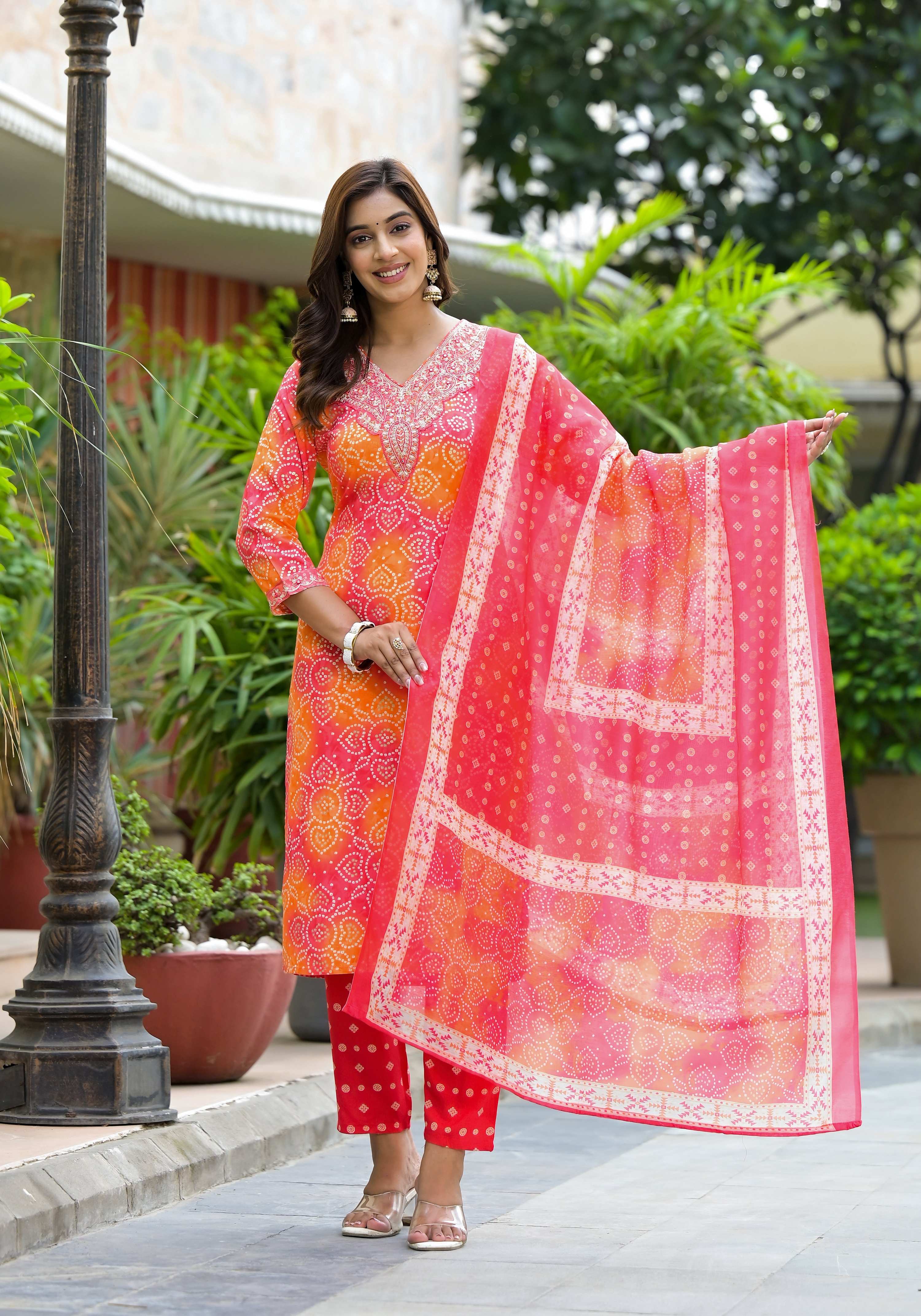 Orange Bandhani printed rayon kurta set with applique embroidery, matching pants, and dupatta.