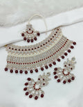 Elegant maroon stone work necklace set with matching earrings and maang tikka