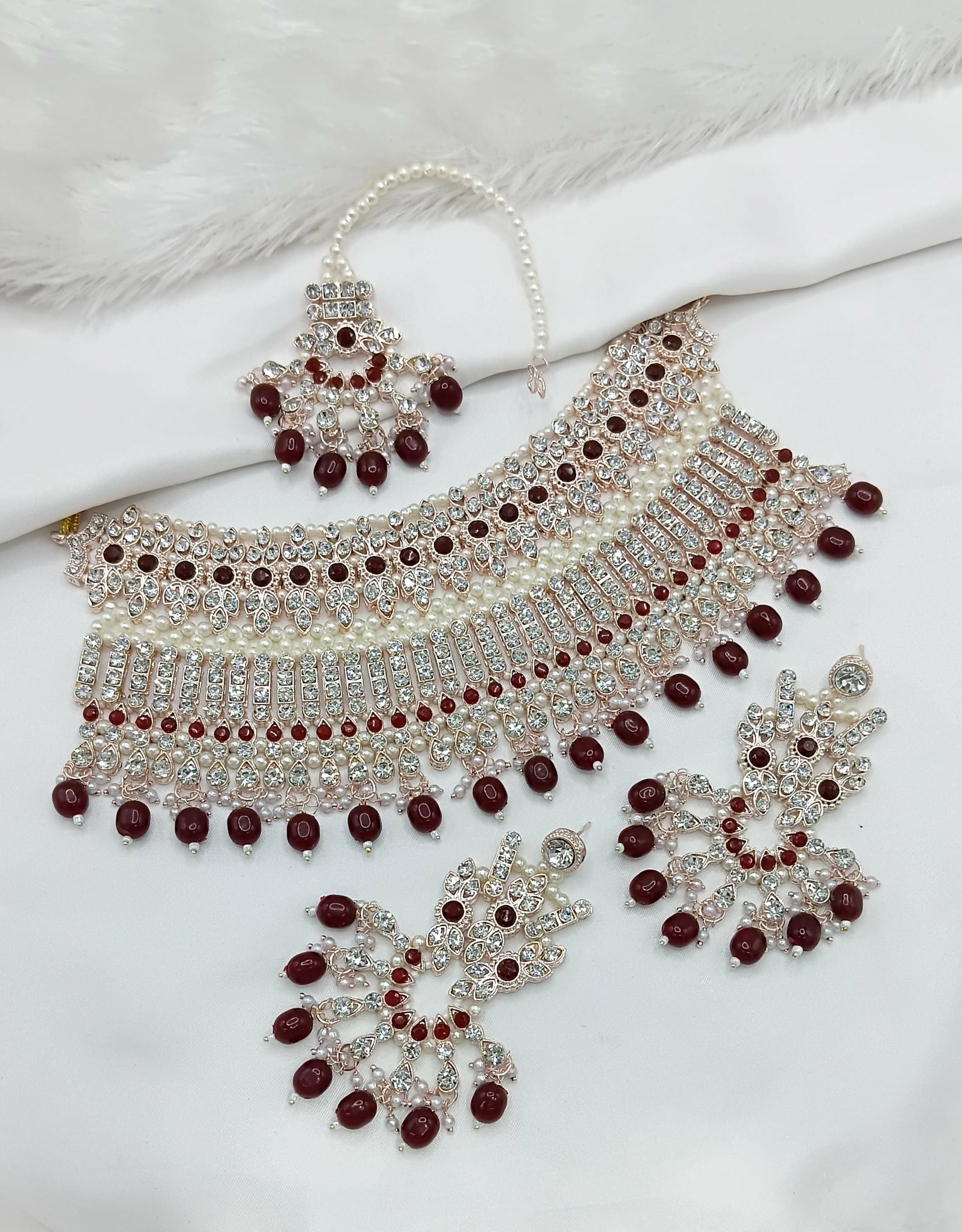 Elegant maroon stone work necklace set with matching earrings and maang tikka