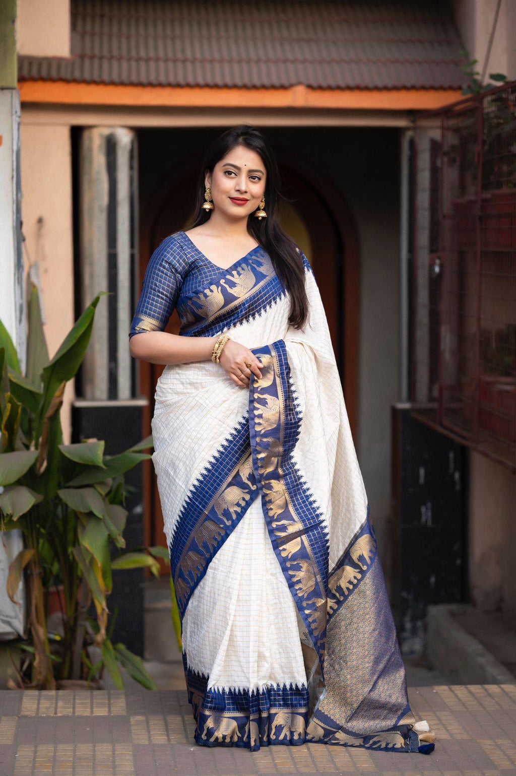 Nblue soft silk saree with zari woven chex pattern and traditional elephant border
