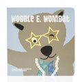 A square board book titled Wobble E. Wombat featuring a cute brown wombat wearing star-shaped glasses and a pearl necklace.