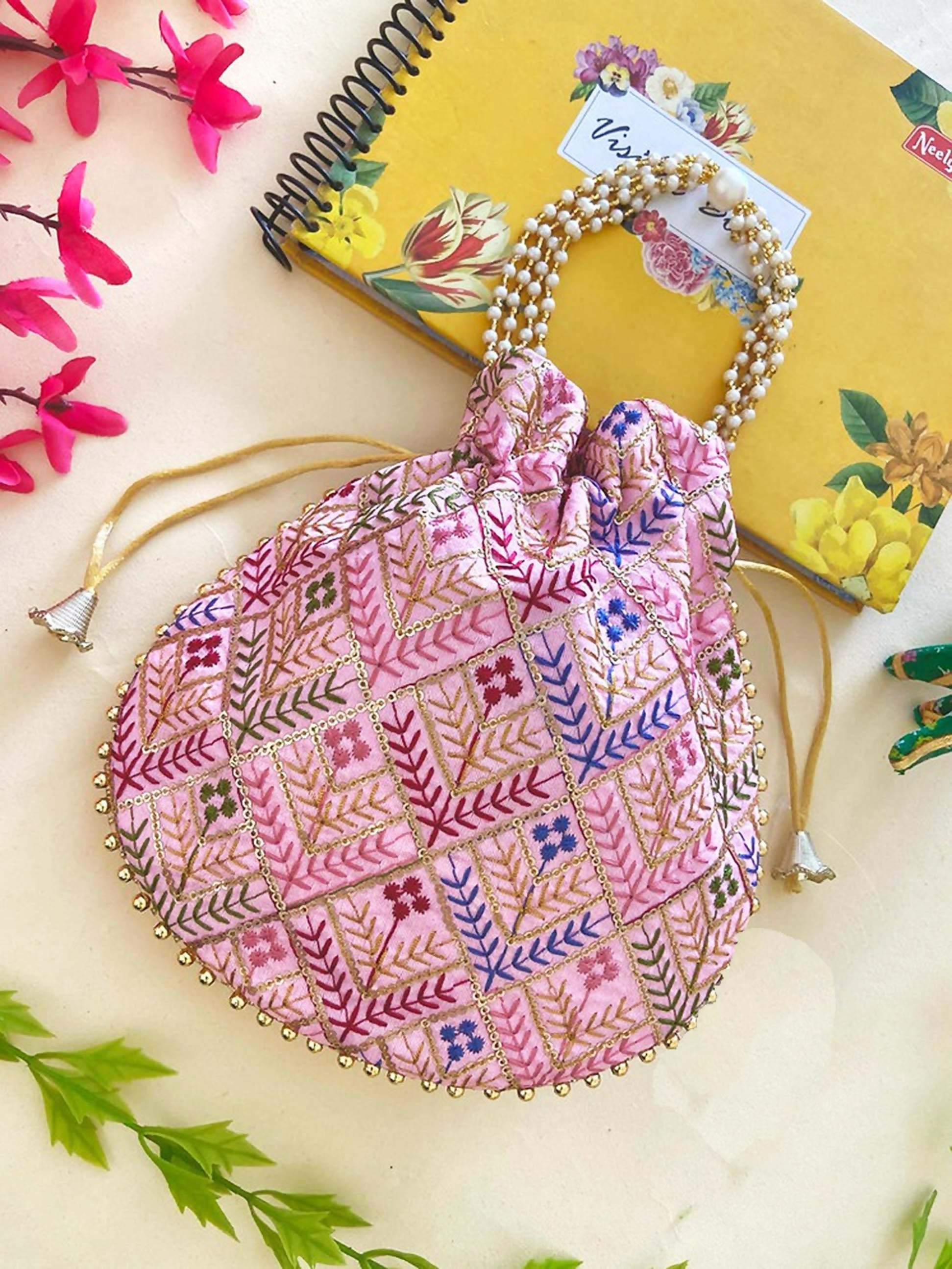 A stylish pink synthetic potli bag featuring a compact 9x9 inch design for ethnic occasions