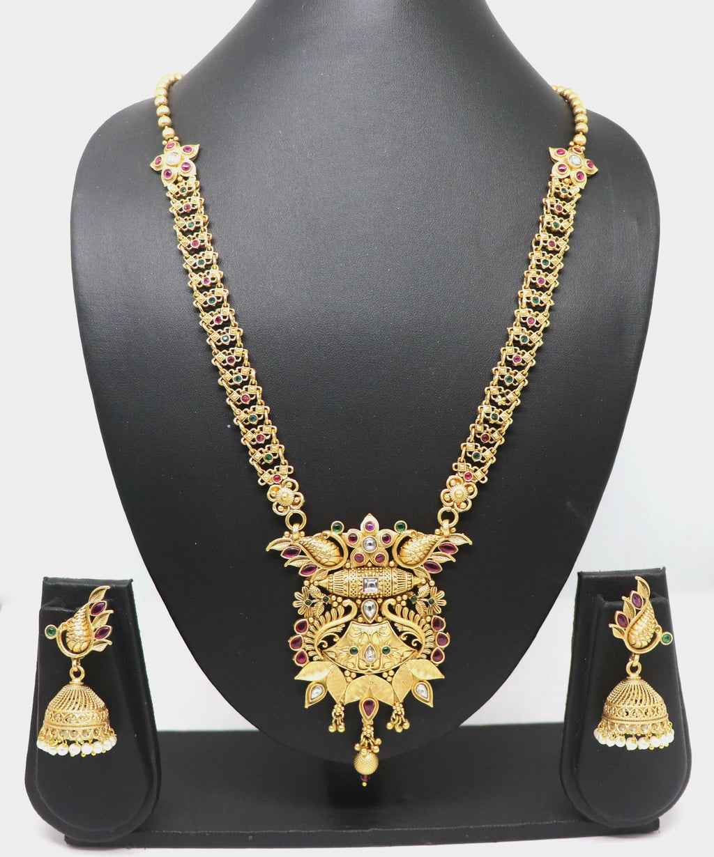 Elegant pure brass necklace set with Rajwadi polish and stone embellishments on a display stand.