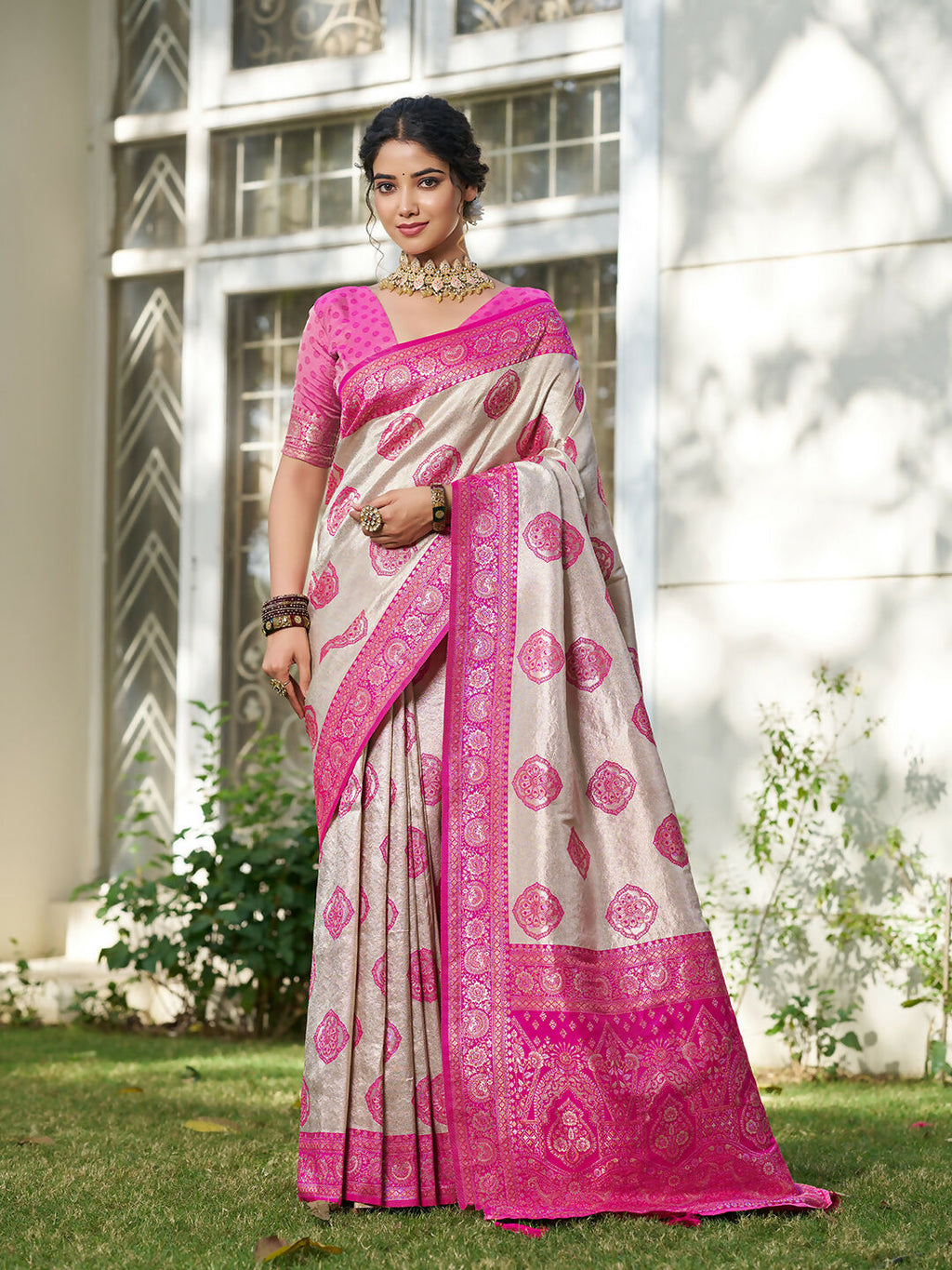 Elegant cream and pink silk blend saree with matching blouse draped gracefully