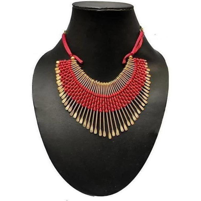 Detailed view of a red and gold threaded necklace featuring traditional craftsmanship