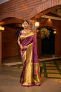 Elegant wine colored Paithani silk saree with zari woven border and matching blouse piece.
