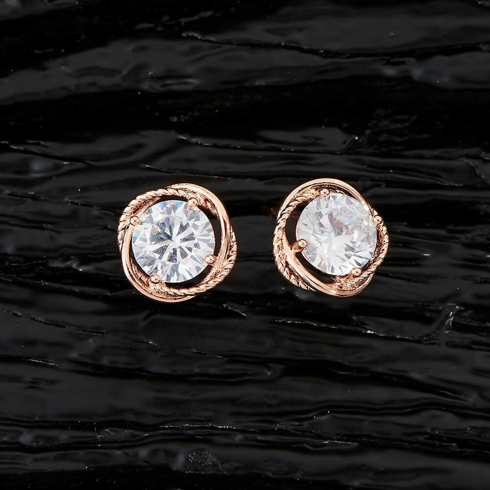 A pair of elegant golden brass earrings featuring white AD stones for women