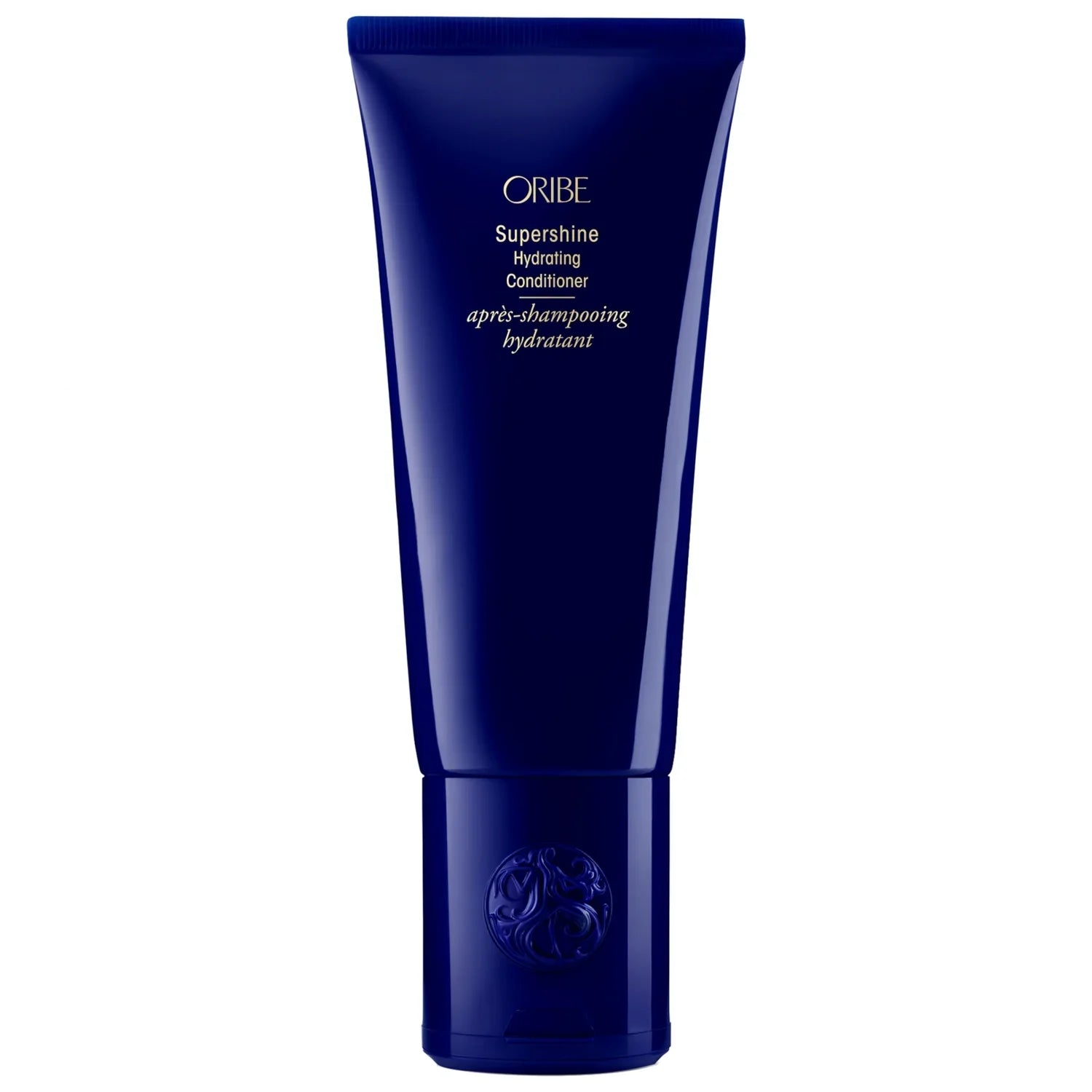 Oribe Supershine Hydrating Conditioner in a deep navy blue tube with gold foil lettering.